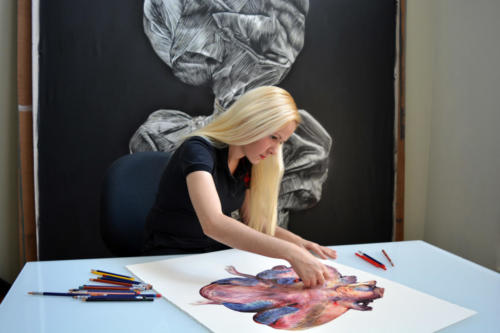 Artist at work on paper