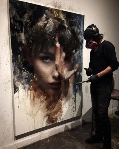 Casey Baught in his studio with a work from Exposed Serie
