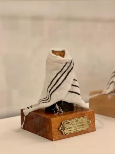 Donning the Tallit by Stve Marcus, 2018. Bass Wood, Milk Paint, Tung Oil, Torah Ink and Mixed Media. 2.25x3.75x 3.5.